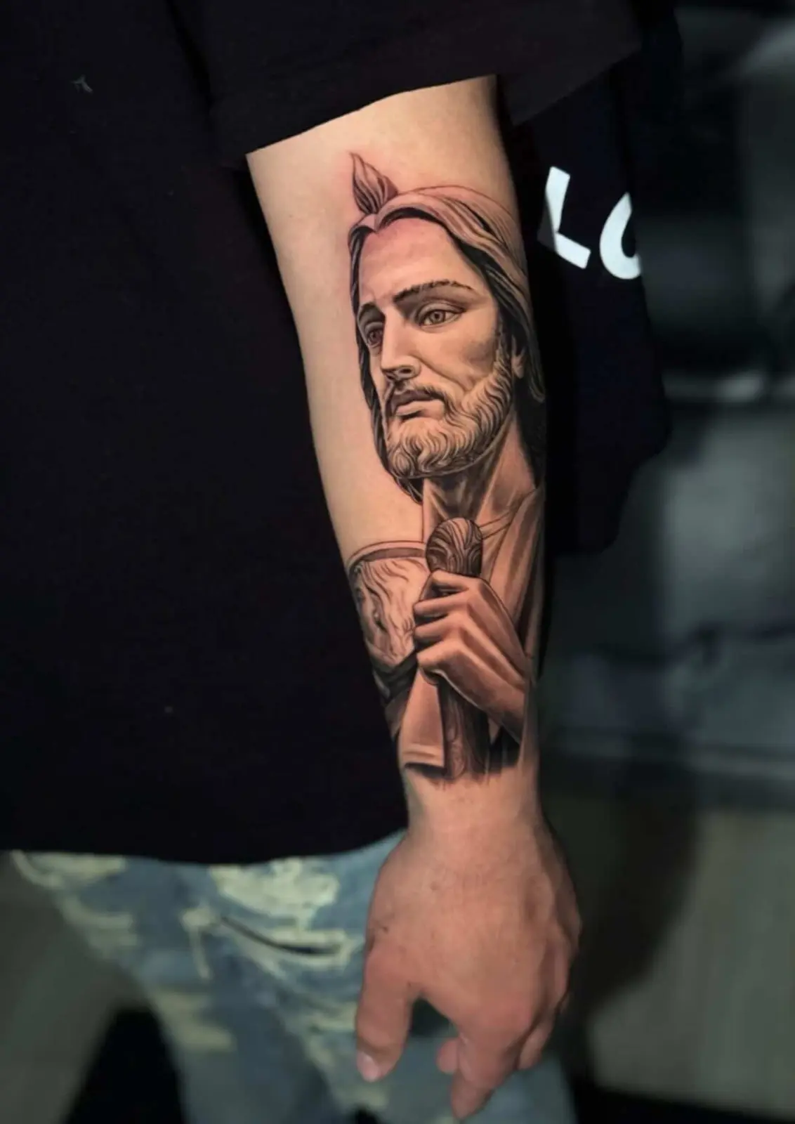 Black-and-gray portrait forearm tattoo