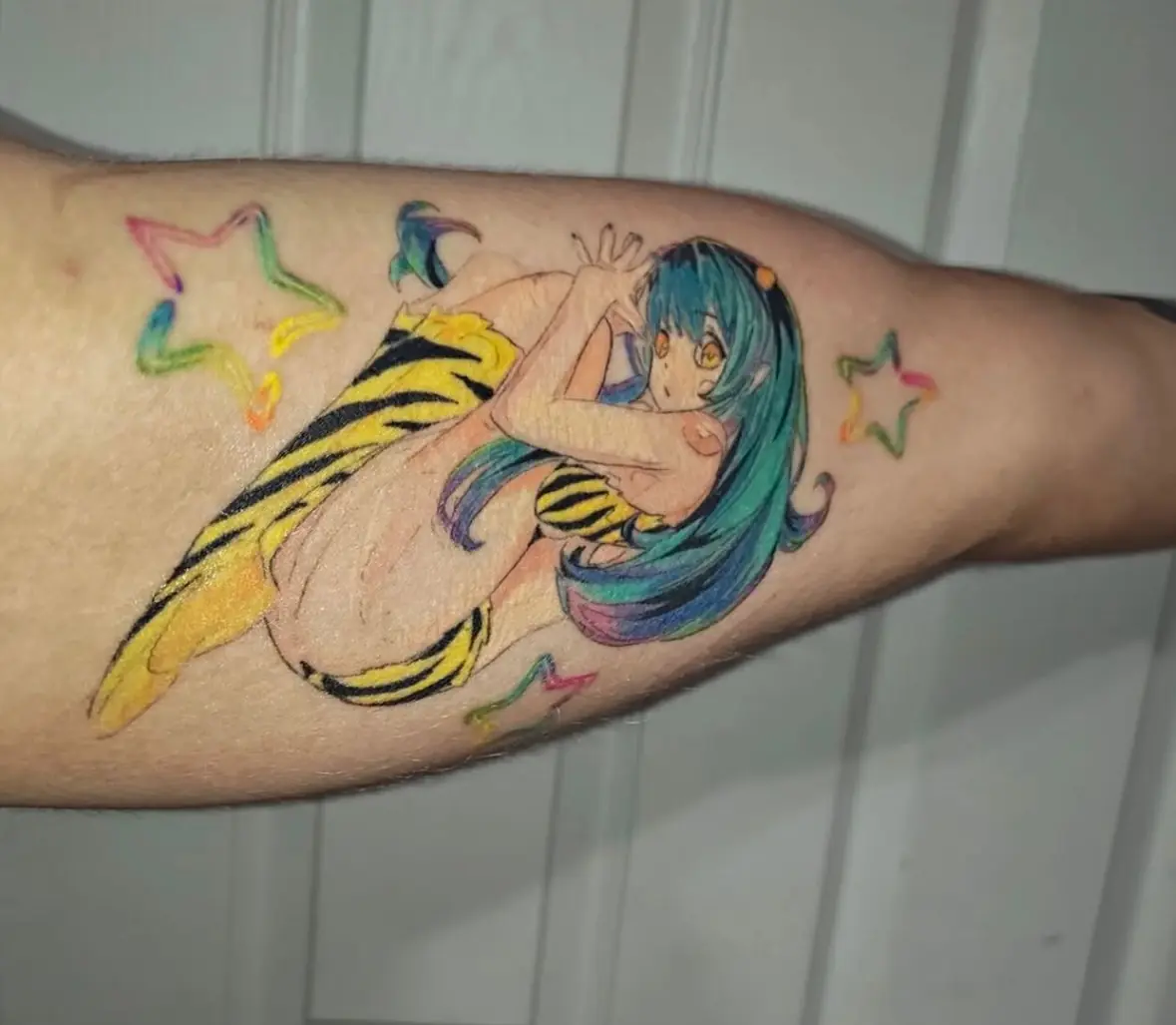 Bright color anime tattoo on an arm