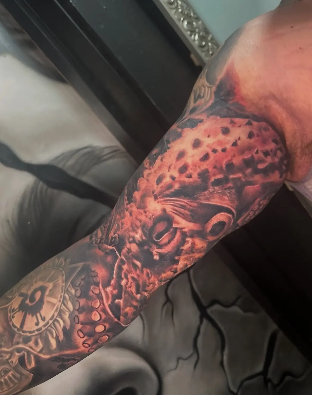 Detailed black-and-gray full sleeve tattoo