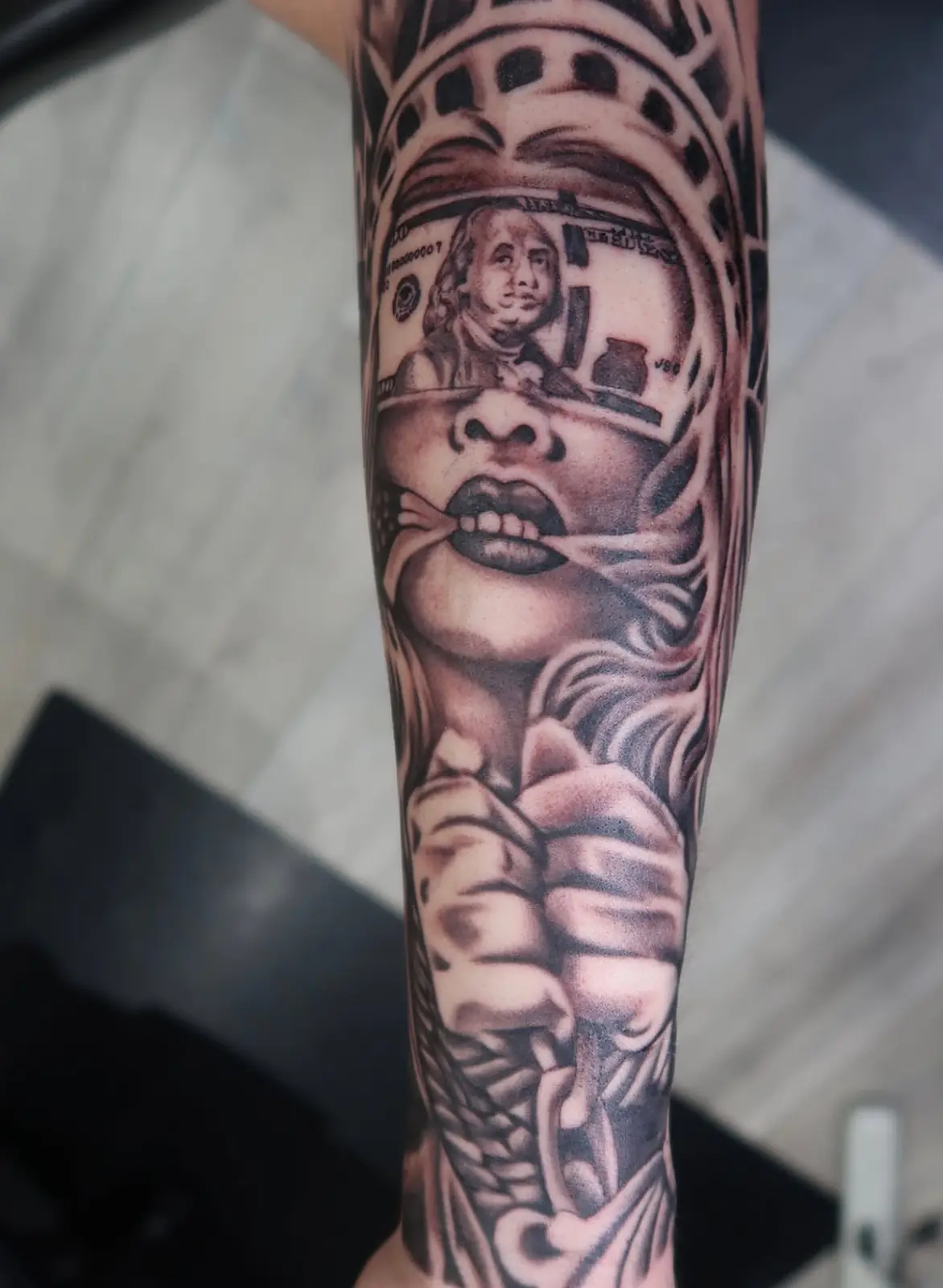 Black-and-gray woman portrait sleeve tattoo