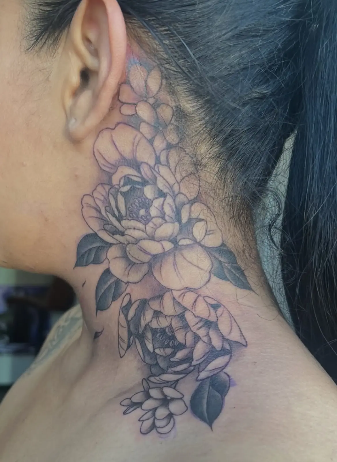 Fine-line floral neck tattoo